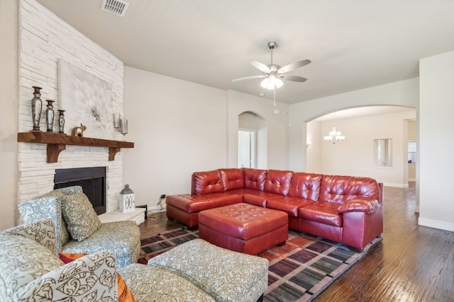 living room with arched walkways, hardwood / wood-style floors, a ceiling fan, and baseboards
