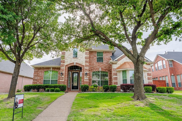 3221 Summerfield Dr, Richardson, TX 75082 - traditional-style home featuring brick siding, a front yard, and a shingled roof