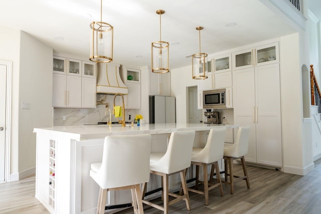 3221 Summerfield Dr, Richardson, TX 75082 - kitchen featuring stainless steel microwave, freestanding refrigerator, custom range hood, tasteful backsplash, and light wood-type flooring