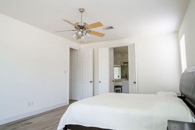 3221 Summerfield Dr, Richardson, TX 75082 - bedroom featuring light wood-type flooring, baseboards, ceiling fan, and connected bathroom