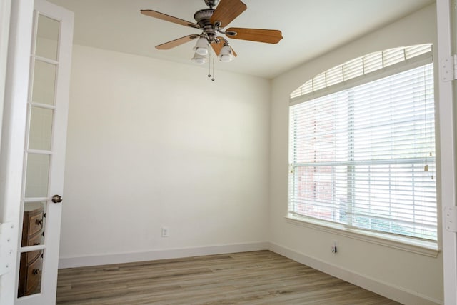 3221 Summerfield Dr, Richardson, TX 75082 - spare room featuring light wood-style floors, a ceiling fan, and baseboards