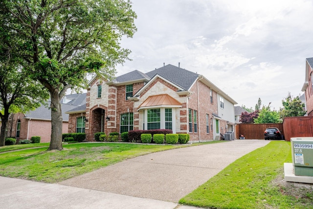 3221 Summerfield Dr, Richardson, TX 75082 - view of front of house with brick siding, roof with shingles, and central AC