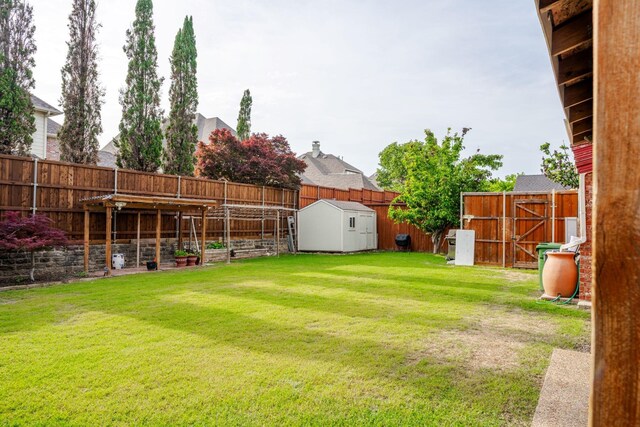3221 Summerfield Dr, Richardson, TX 75082 - view of yard featuring a storage unit and an outbuilding