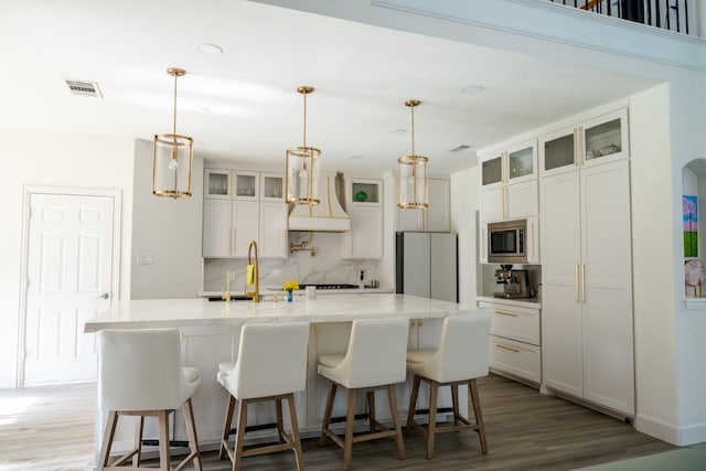 3221 Summerfield Dr, Richardson, TX 75082 - kitchen featuring appliances with stainless steel finishes, premium range hood, a sink, decorative backsplash, and wood finished floors