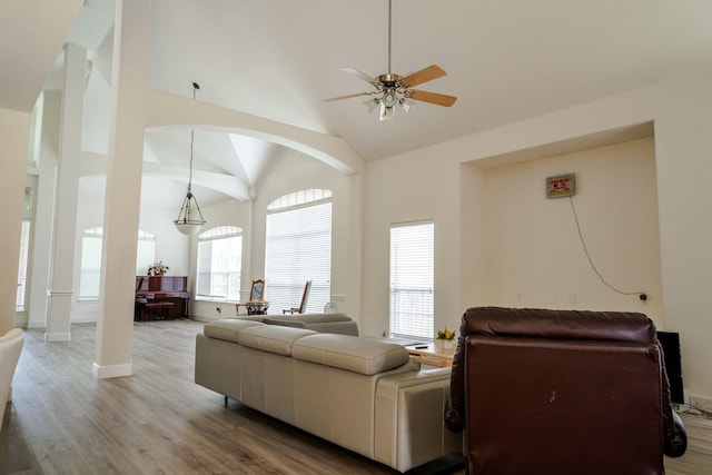 3221 Summerfield Dr, Richardson, TX 75082 - living area with a ceiling fan, light wood-style floors, high vaulted ceiling, arched walkways, and baseboards