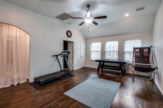 exercise room with ceiling fan, lofted ceiling, wood finished floors, arched walkways, and baseboards