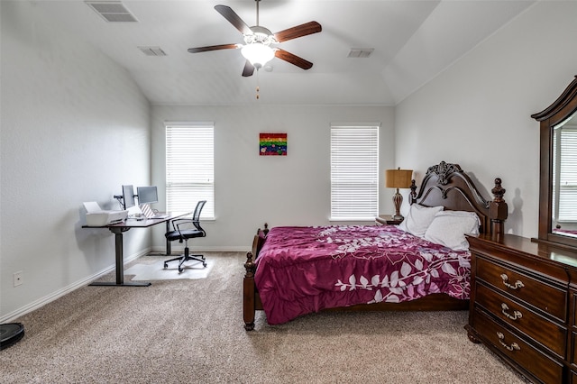bedroom featuring lofted ceiling, light carpet, a desk, baseboards, and a ceiling fan