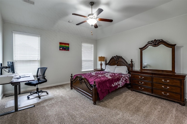 bedroom featuring carpet floors, multiple windows, a desk, and baseboards