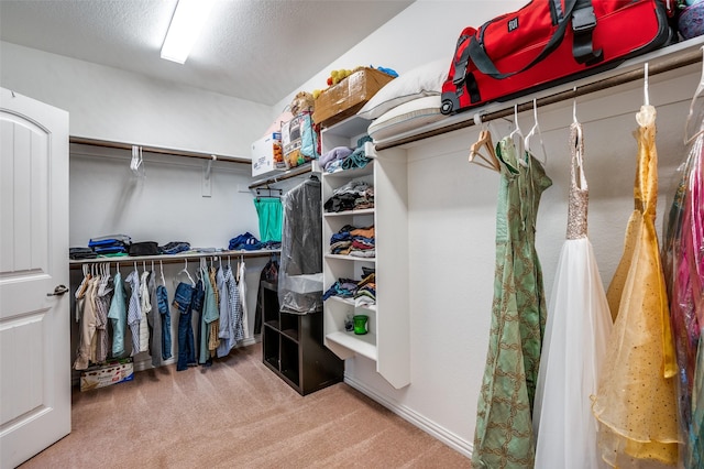 walk in closet featuring carpet floors