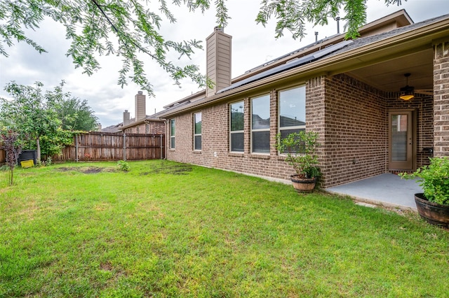 view of yard featuring a patio area and a ceiling fan