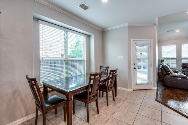 dining room featuring crown molding, baseboards, light tile patterned floors, and recessed lighting
