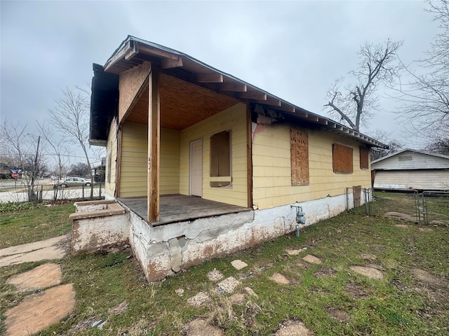 1805 Fillmore St, Wichita Falls, TX 76309 - view of side of home with fence and a porch