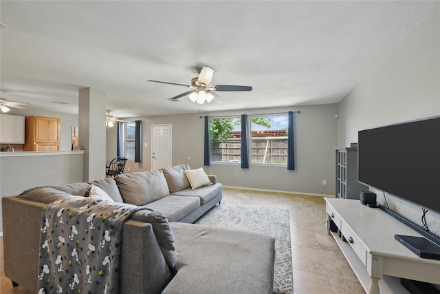 1833 Ramada Trl, Fort Worth, TX 76247 - living room featuring ceiling fan, light tile patterned flooring, and baseboards