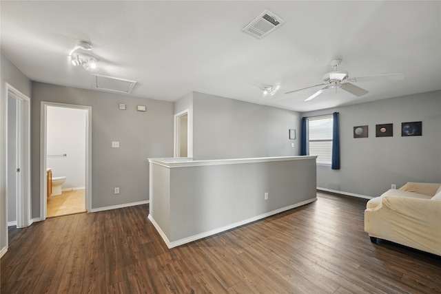 1833 Ramada Trl, Fort Worth, TX 76247 - sitting room with attic access, dark wood-style flooring, baseboards, a ceiling fan, and an upstairs landing