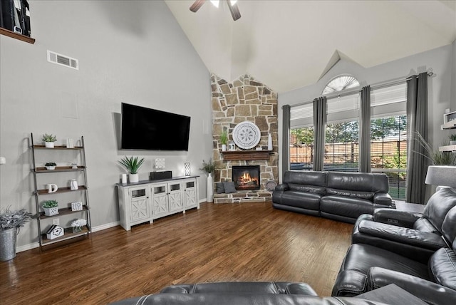 living room with ceiling fan, wood finished floors, a fireplace, high vaulted ceiling, and baseboards