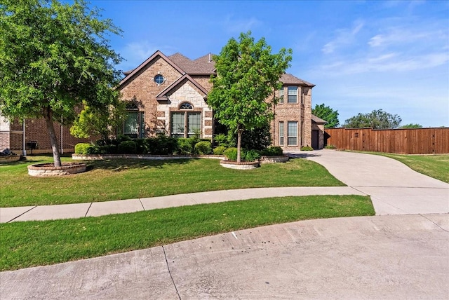 view of front facade with stone siding, driveway, and brick siding