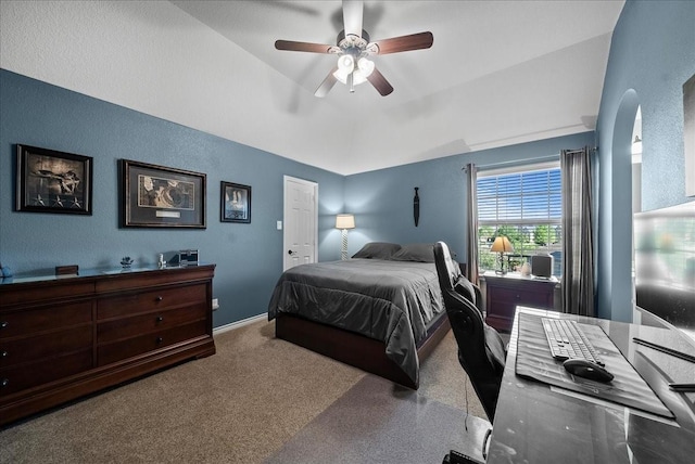 bedroom with vaulted ceiling, ceiling fan, baseboards, a desk, and carpet flooring