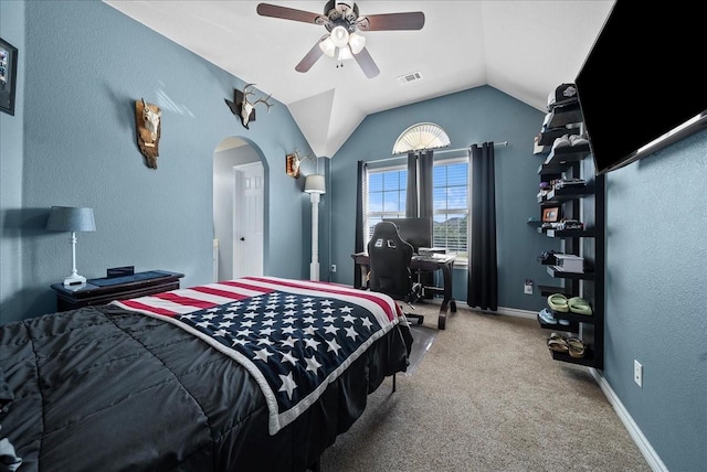 bedroom featuring carpet floors, arched walkways, vaulted ceiling, ceiling fan, and an office area