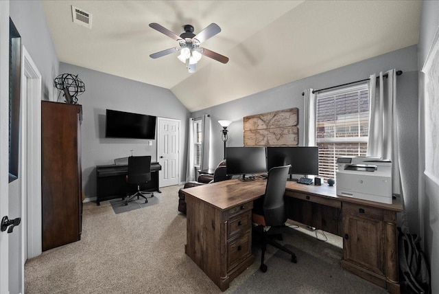 office area featuring lofted ceiling, a ceiling fan, and light carpet