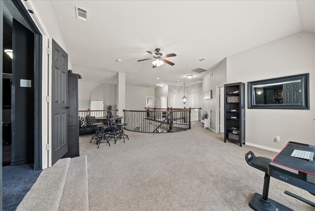 living room with carpet floors, a ceiling fan, and baseboards