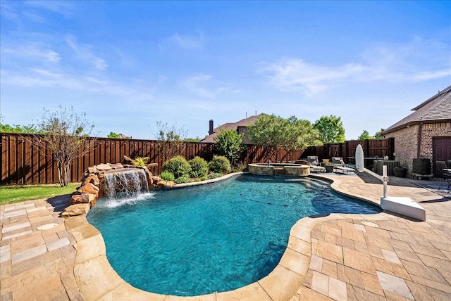 view of swimming pool featuring a fenced backyard, a patio area, and a pool with connected hot tub