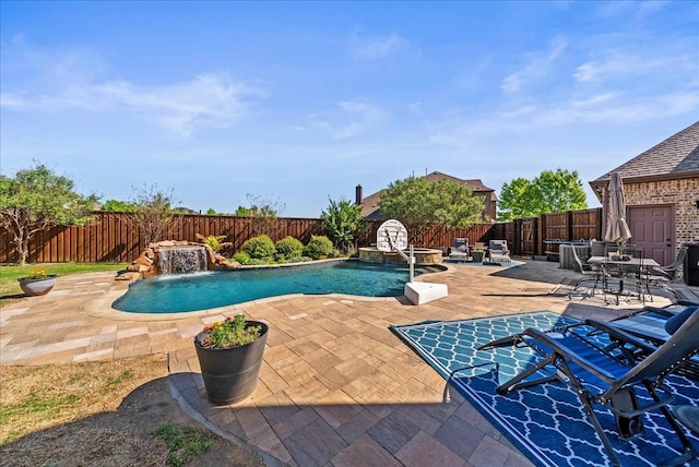 view of swimming pool with a fenced backyard, a patio, and a pool with connected hot tub