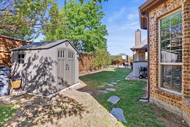 view of yard featuring a shed and an outbuilding