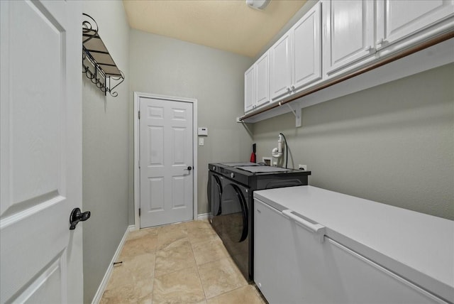 laundry room featuring cabinet space, washer and dryer, and baseboards