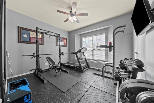 exercise area featuring baseboards and a ceiling fan
