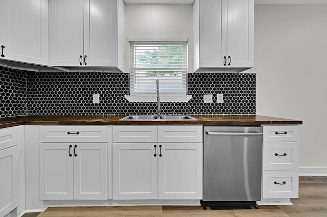 1713 Reuter Ave, Waco, TX 76708 - kitchen with stainless steel dishwasher, a sink, white cabinets, and tasteful backsplash