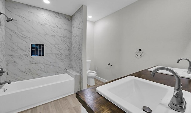 1713 Reuter Ave, Waco, TX 76708 - bathroom with a sink, wood finished floors, toilet, recessed lighting, and washtub / shower combination