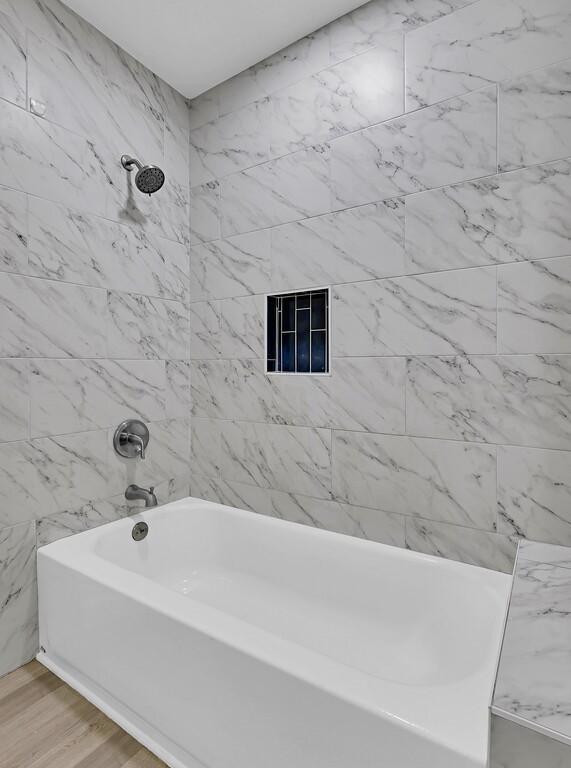 1713 Reuter Ave, Waco, TX 76708 - full bathroom featuring tub / shower combination and wood finished floors
