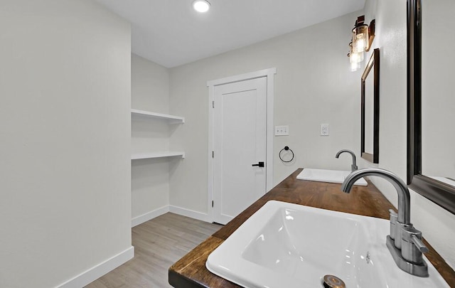 1713 Reuter Ave, Waco, TX 76708 - bathroom with a sink, wood finished floors, and baseboards