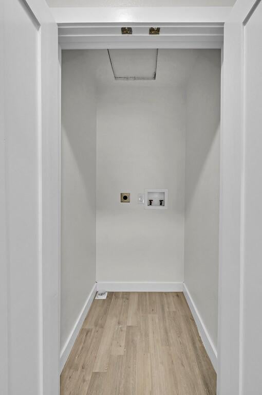1713 Reuter Ave, Waco, TX 76708 - clothes washing area with hookup for an electric dryer, light wood-style floors, hookup for a washing machine, and baseboards