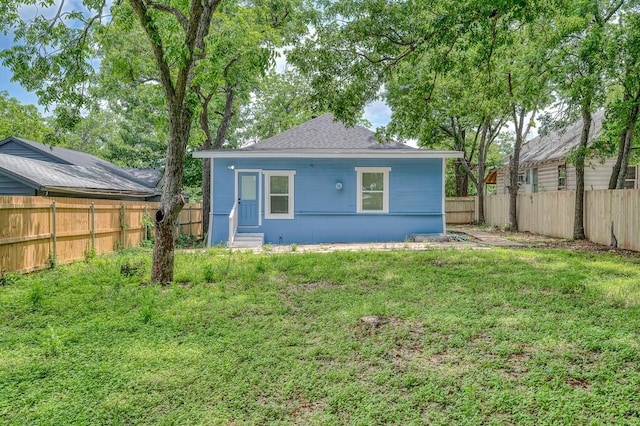 1713 Reuter Ave, Waco, TX 76708 - rear view of house with a shingled roof and entry steps