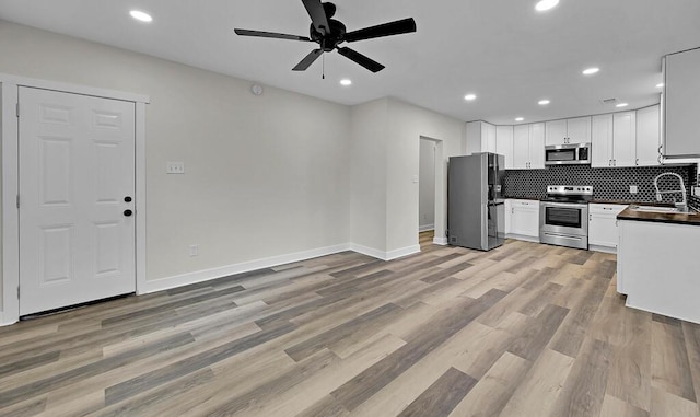 1713 Reuter Ave, Waco, TX 76708 - kitchen with stainless steel appliances, dark countertops, ceiling fan, a sink, and tasteful backsplash