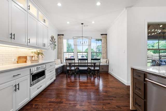 kitchen with stainless steel appliances, ornamental molding, tasteful backsplash, dark wood-style floors, and recessed lighting