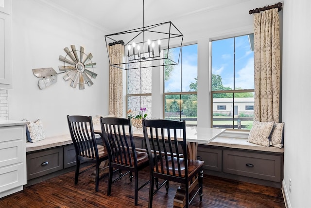 dining area with a chandelier, dark wood finished floors, and crown molding