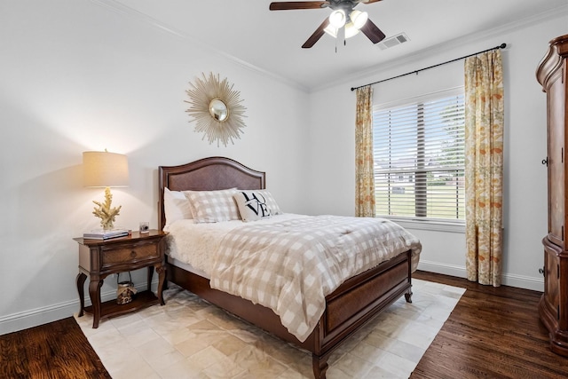 bedroom featuring crown molding, baseboards, light wood-type flooring, and ceiling fan