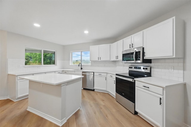 3169 Longbow Dr, Grand Prairie, TX 75052 - kitchen featuring appliances with stainless steel finishes, a sink, light wood-style flooring, white cabinets, and recessed lighting