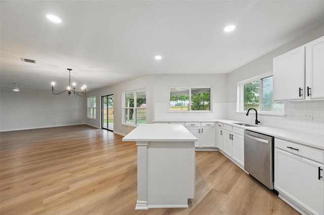 3169 Longbow Dr, Grand Prairie, TX 75052 - kitchen featuring stainless steel dishwasher, a sink, a chandelier, a center island, and light wood-style flooring
