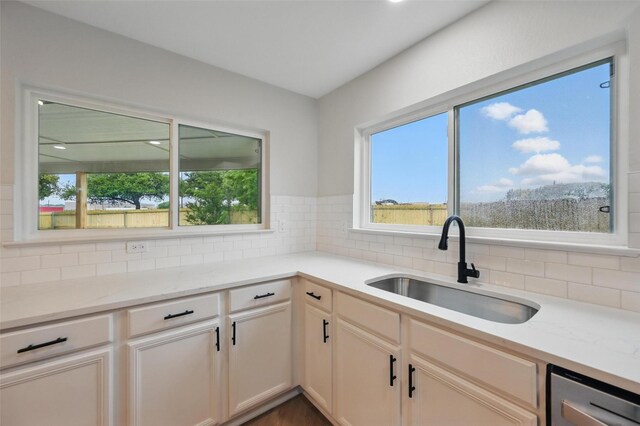 3169 Longbow Dr, Grand Prairie, TX 75052 - kitchen with a sink, backsplash, dishwasher, and light stone counters