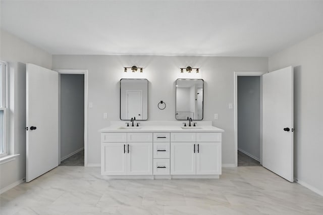 3169 Longbow Dr, Grand Prairie, TX 75052 - bathroom featuring marble finish flooring, double vanity, and baseboards