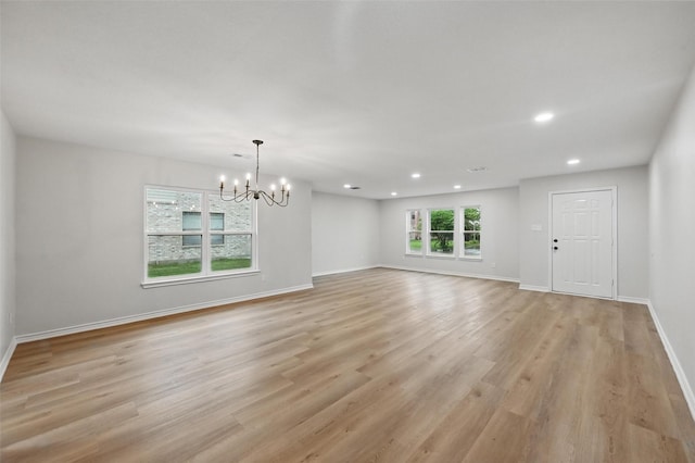 3169 Longbow Dr, Grand Prairie, TX 75052 - unfurnished living room with a chandelier, recessed lighting, light wood-style floors, and baseboards