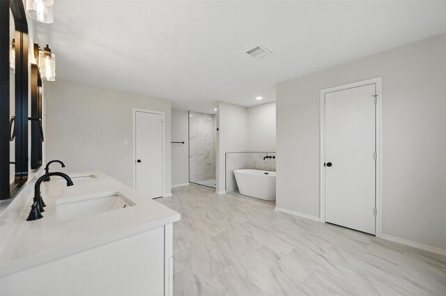 3169 Longbow Dr, Grand Prairie, TX 75052 - bathroom featuring a marble finish shower, a freestanding bath, double vanity, recessed lighting, and baseboards