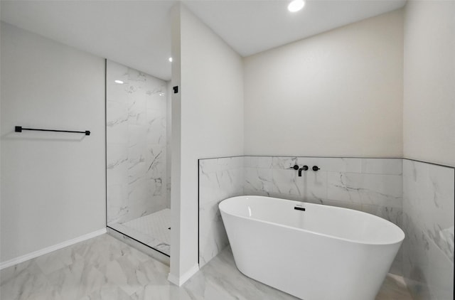 3169 Longbow Dr, Grand Prairie, TX 75052 - bathroom featuring marble look tiles, a soaking tub, a marble finish shower, recessed lighting, and baseboards