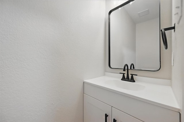 3169 Longbow Dr, Grand Prairie, TX 75052 - bathroom with vanity and a textured wall