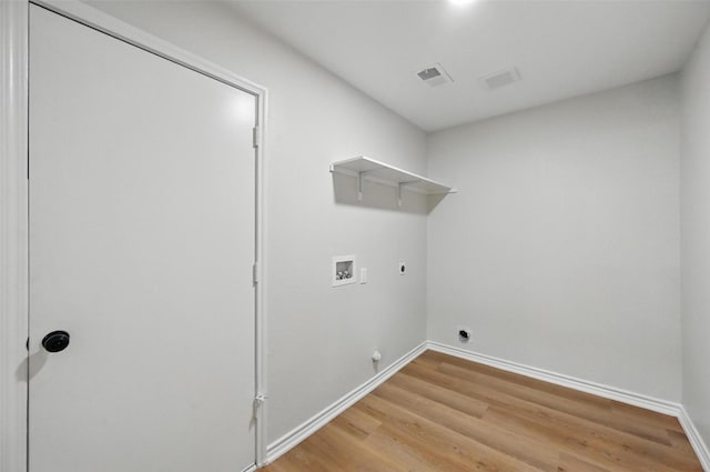 3169 Longbow Dr, Grand Prairie, TX 75052 - laundry area with hookup for a washing machine, electric dryer hookup, light wood-style floors, hookup for a gas dryer, and baseboards