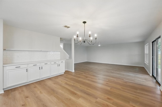 3169 Longbow Dr, Grand Prairie, TX 75052 - unfurnished dining area featuring a chandelier, light wood-style flooring, and baseboards