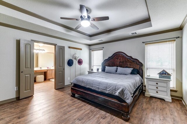 870 1st St, Maypearl, TX 76064 - bedroom with a raised ceiling, ornamental molding, wood finished floors, a textured ceiling, and baseboards